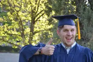 a graduate making a thumbs up sign