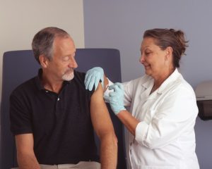 family nurse administering vaccine - featured image