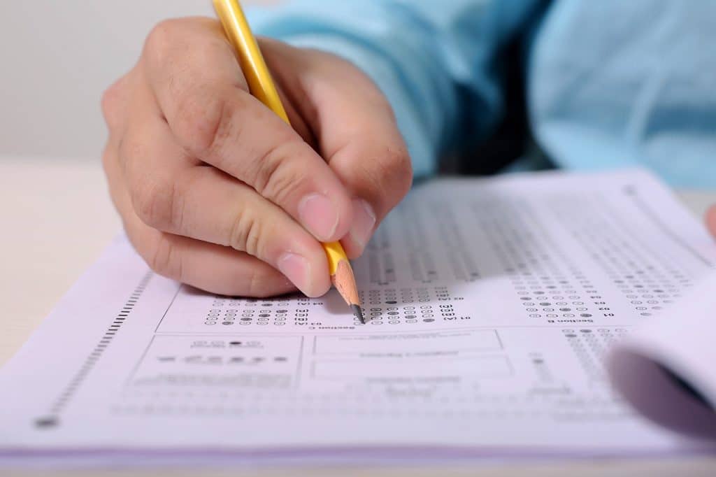 young guy taking exam - featured image