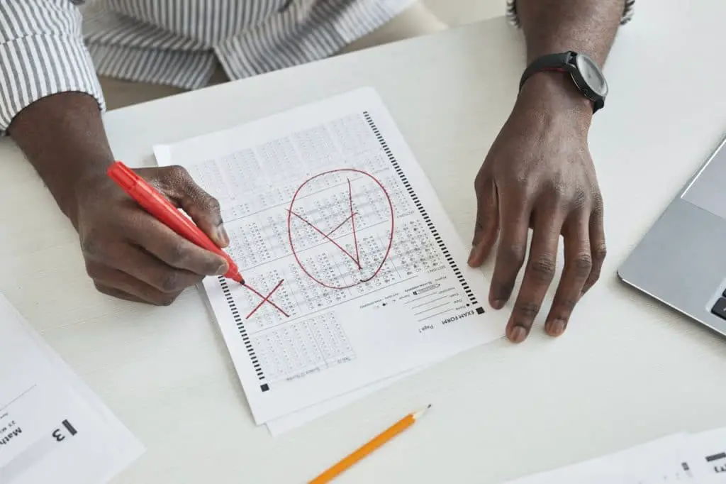 person marking a test paper - featured image