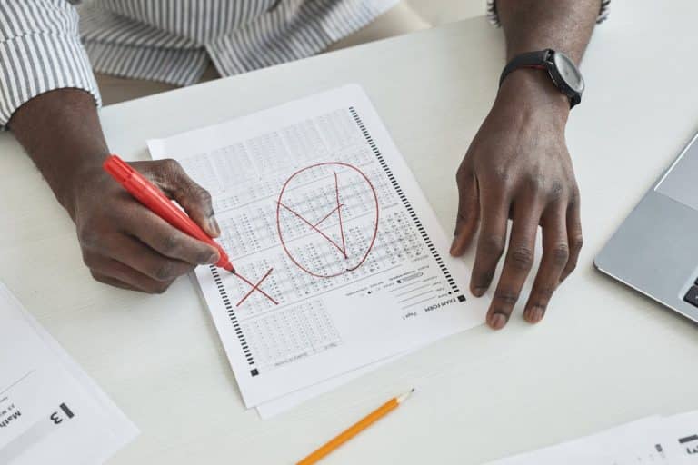 person marking a test paper - featured image