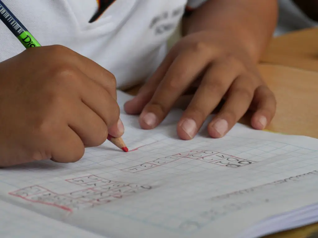 student writing on graphing notebook