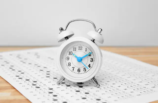 alarm clock on top of test paper