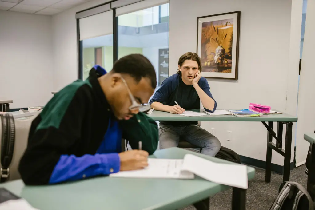 male students taking exam - featured image